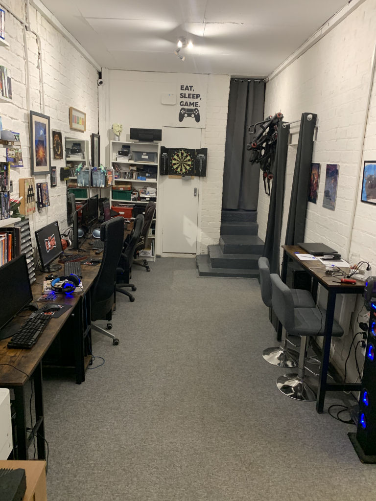 View looking toward the north wall featuring gaming PCs and darts board